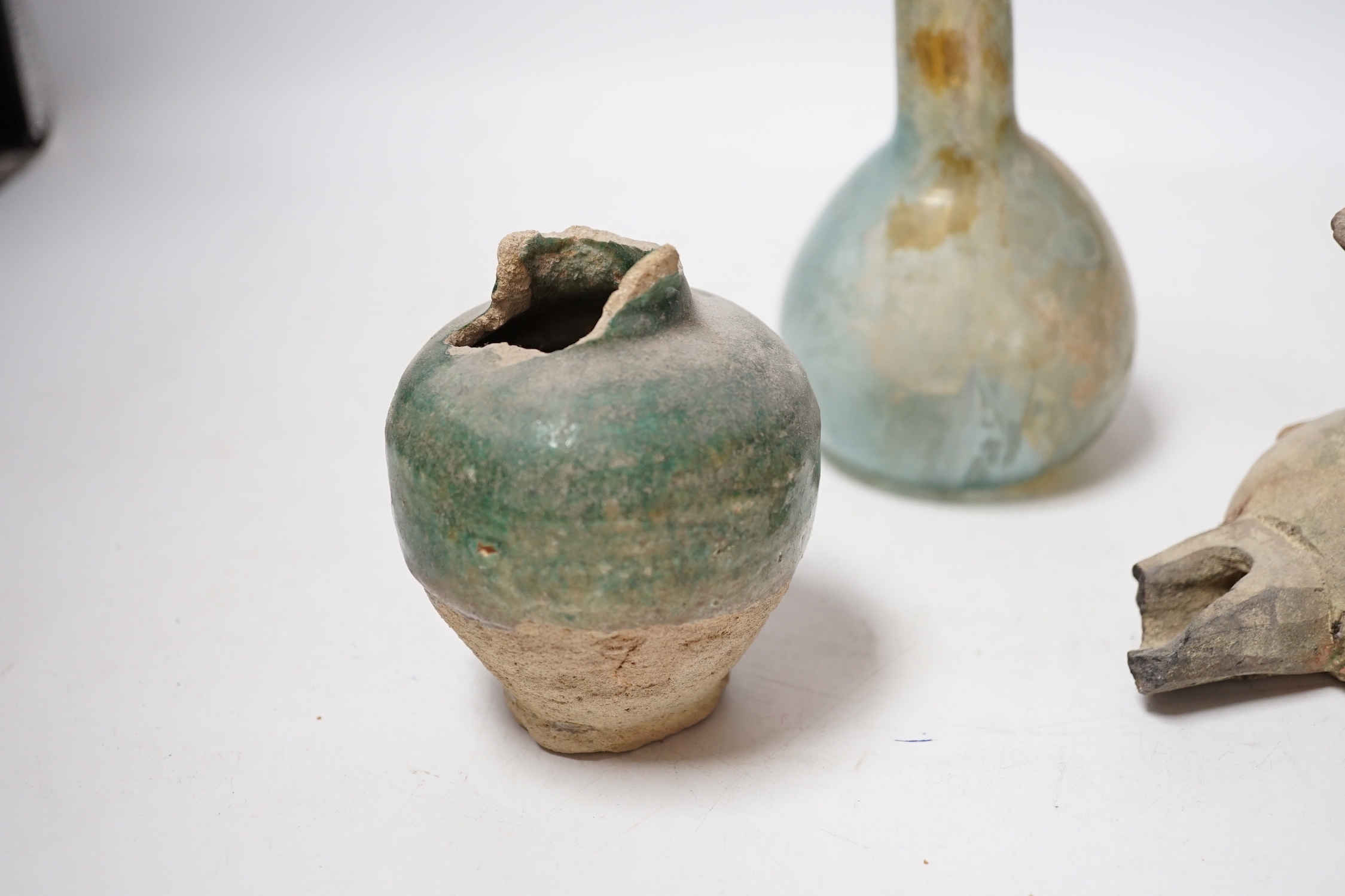 A Roman glass vessel, an Islamic pot and oil lamp, largest 18cm high (3)